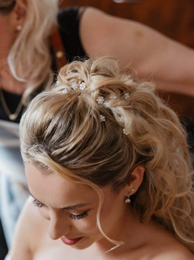 An occasion updo with small pearls, made at TOP 13