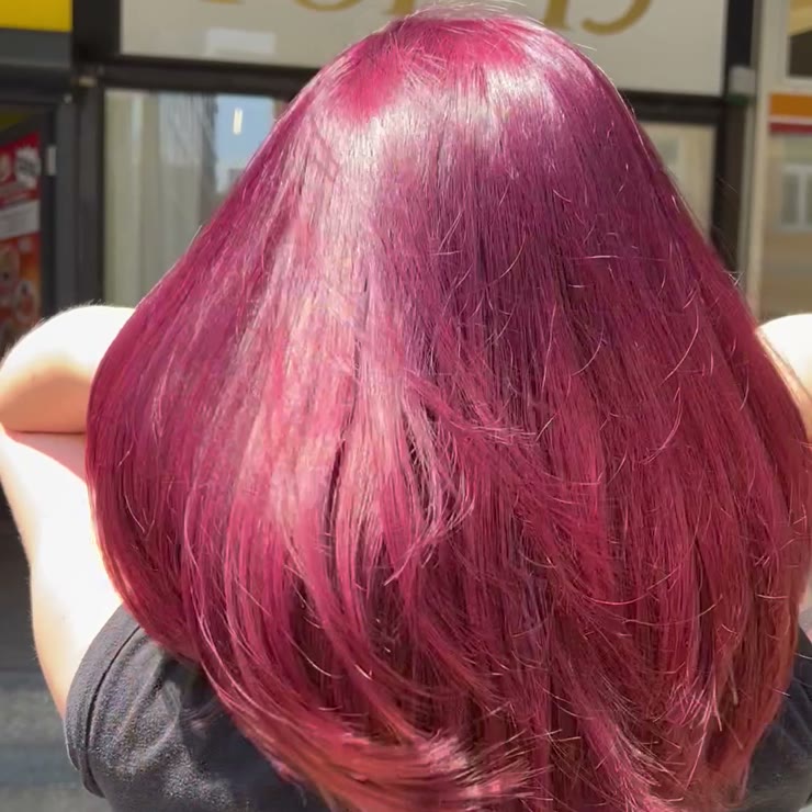 Vivid raspberry red hair outside the entrance to TOP 13