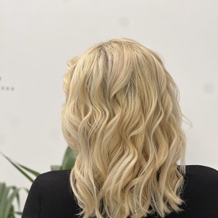 Shoulder-length blonde waves after styling