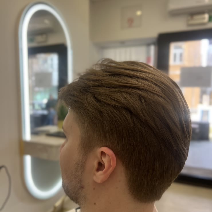 A men's fade with more length on top, side view