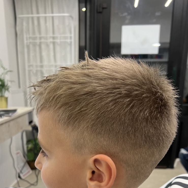 A boy with a fresh short haircut