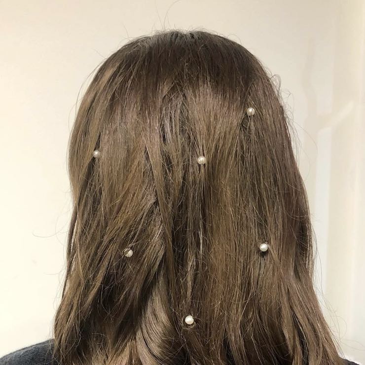 A half-up style with waves and small pearls