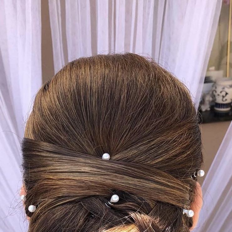 An updo with interwoven strands and pearls