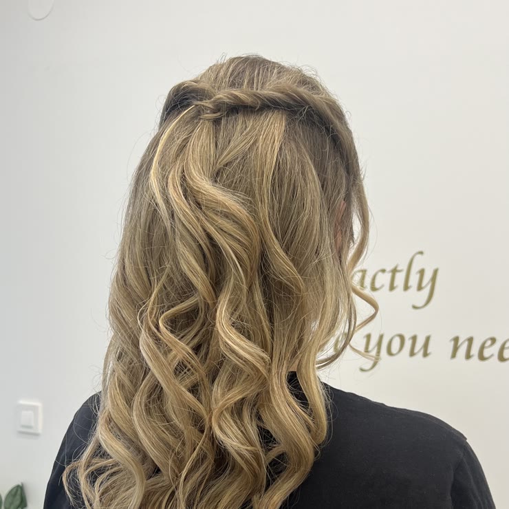 A half-up style with a braided strand and waves