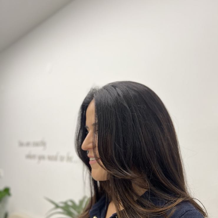 A layered shoulder-length women's cut, seen from behind