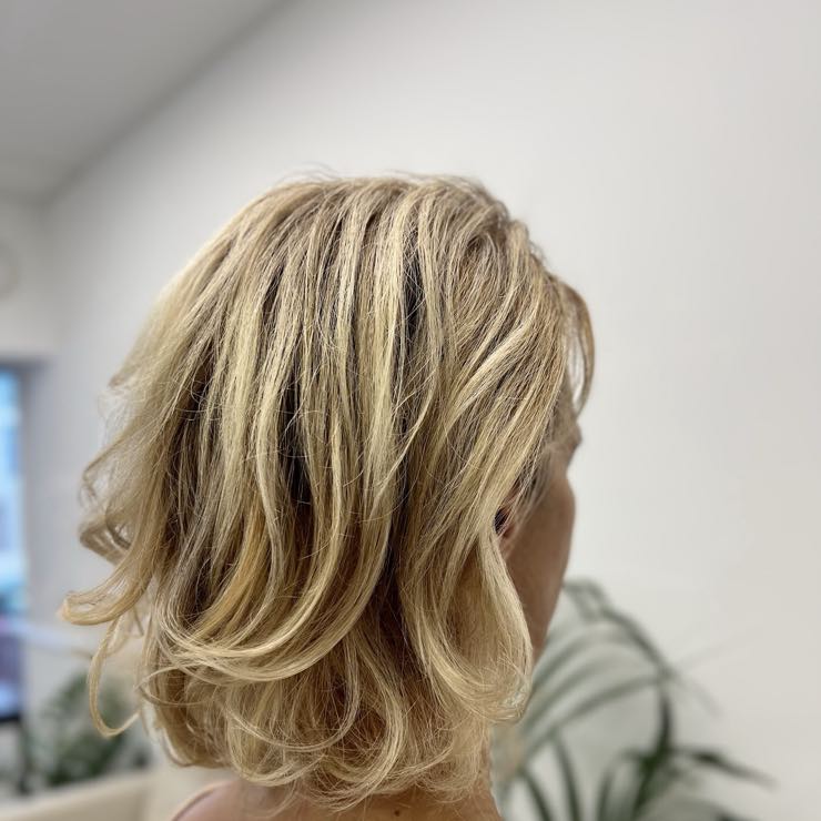 A layered blonde cut, shoulder length