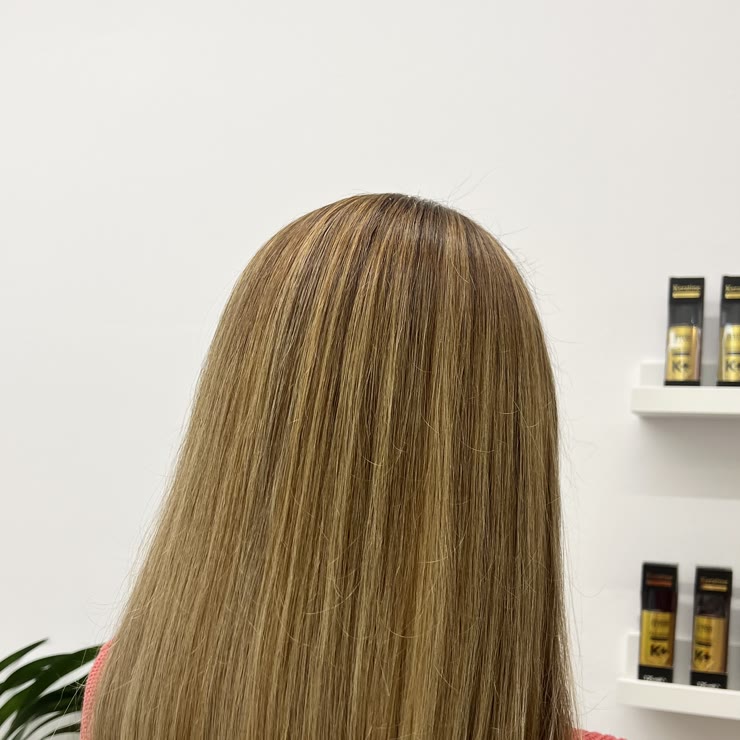 A brown bob with golden highlights, seen from behind