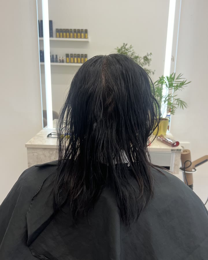 The same hair before colouring – dark and wet, the client in a gown